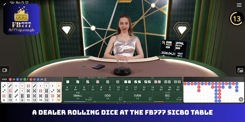 A dealer rolling dice at the FB777 Sicbo table